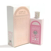 Perfume bottle with decorative packaging on a white background