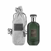 Green perfume bottle with gray drawstring bag on a white background
