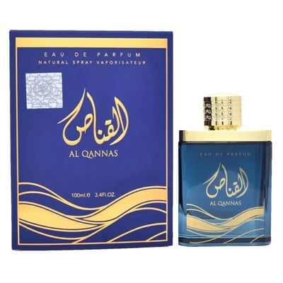 Ard Al Zaafaran Al Qannas Eau De Parfum 100ml — A blue perfume bottle and its matching blue box with gold Arabic calligraphy and wavy lines, displayed side-by-side on a white background. | Ard Al Zaafaran Al Qannas Eau De Parfum 100ml — Botol minyak wangi biru dan kotak birunya yang sepadan dengan kaligrafi Arab emas