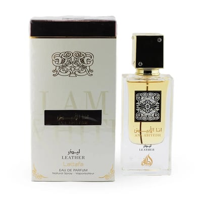 Lattafa Ana Abiyedh Leather 60ml by Lattafa Perfumes — A white perfume box with gold Arabic calligraphy and a clear glass bottle with gold accents and a dark brown cap, displayed side-by-side. | Lattafa Ana Abiyedh Leather 60ml by Lattafa Perfumes — Kotak minyak wangi putih dengan kaligrafi Arab emas dan botol kaca