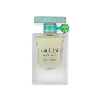 Lattafa Atlas Glacial Valley — Kotak biru muda bertekstur berdiri sebelah botol minyak wangi kaca jernih berisi cecair kuning pucat. Kotak ada jalur hijau menegak dan grafik pokok. Penutup teal pada botol ada loket pokok.