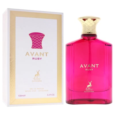 Maison Alhambra Avant Ruby Eau De Parfum 100ml — A bright pink glass perfume bottle with a gold textured cap stands next to its white and gold patterned box, both featuring the Avant Ruby branding and a deer logo. | Maison Alhambra Avant Ruby Eau De Parfum 100ml — Botol kaca berwarna merah jambu terang dengan penutup
