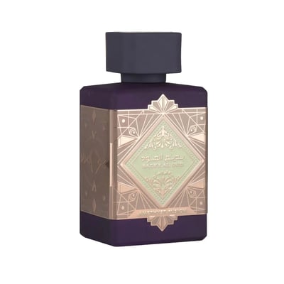 Lattafa Bade'e Al Oud Amethyst Fusion 100ml — A purple perfume bottle with a gold geometric label sits next to its matching box, which has a gold frame and a window showing the bottle inside. | Lattafa Bade'e Al Oud Amethyst Fusion 100ml — Botol minyak wangi ungu dengan label geometri emas duduk bersebelahan dengan