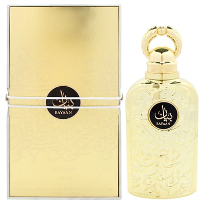 Lattafa Bayaan Eau De Parfum — A gold-colored perfume bottle with ornate Arabic script and a gold ring handle sits next to its matching gold box, also adorned with script and a circular logo. | Lattafa Bayaan Eau De Parfum — Botol minyak wangi berwarna emas dengan skrip Arab berhias dan pemegang cincin emas duduk