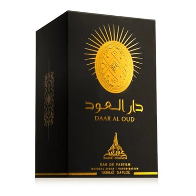 Paris Corner Daar Al Oud Intense 100ml — Black box with gold sunburst and Arabic script next to a glass perfume bottle with gold cap and matching design | Paris Corner Daar Al Oud Intense 100ml — Kotak hitam dengan pancaran matahari emas dan tulisan Arab di sebelah botol minyak wangi kaca dengan penutup emas dan reka