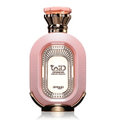 Zimaya Daiman Eden Eau De Parfum 100ml by Zimaya — A pink textured perfume bottle with gold accents stands next to its matching coral-orange textured box with gold marbling. | Zimaya Daiman Eden Eau De Parfum 100ml by Zimaya — Sebotol minyak wangi merah jambu bertekstur dengan perincian emas berdiri di sebelah kotak