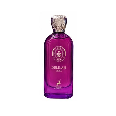 Maison Alhambra Delilah Viola 100ml — A purple glass perfume bottle with a gold cap stands next to its matching purple box, both featuring gold embossed details and a deer logo. | Maison Alhambra Delilah Viola 100ml — Botol kaca ungu berdiri di sebelah kotak ungu sepadan, kedua-duanya menampilkan butiran emas timbul