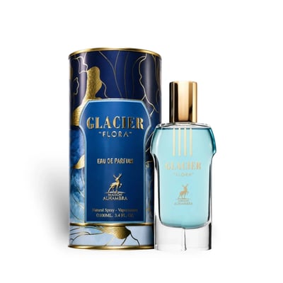 Maison Alhambra Glacier Flora 100ml Maison Alhambra — A blue perfume bottle with a gold cap and vertical gold lines on the glass, stands next to its matching cylindrical blue and gold patterned box on a white background. | Maison Alhambra Glacier Flora 100ml Maison Alhambra — Botol minyak wangi biru dengan penutup