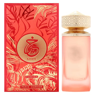 Paris Corner Khair Fusion Her 100ml — Red and gold patterned box next to a frosted pink perfume bottle with a gold textured cap. | Paris Corner Khair Fusion Her 100ml — Kotak corak merah dan emas di sebelah botol minyak wangi merah jambu beku dengan penutup bertekstur emas.