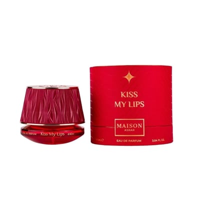 Maison Asrar Kiss My Lips by Maison Asrar 90ml EDP Unisex — Red cylindrical packaging with gold accents, featuring 'KISS MY LIPS' and 'MAISON ASRAR' text. The perfume bottle has a textured, deep red cap and a black base with gold trim, displaying 'Kiss My Lips' and volume details.