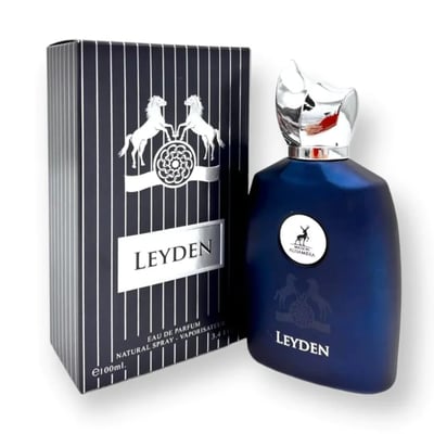 Maison Alhambra Leyden Eau De Parfum — A dark blue perfume bottle and its matching striped box are displayed side-by-side against a white background. The box features two white horses and a circular emblem. | Maison Alhambra Leyden Eau De Parfum — Botol minyak wangi biru gelap dan kotaknya yang berjalur dipamerkan