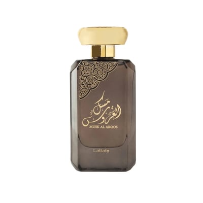 Lattafa Musk Al Aroos by Lattafa 80ml EDP — A black perfume box with gold ornate cutouts and Arabic calligraphy sits next to a dark glass perfume bottle with a gold cap and matching ornate design. | Lattafa Musk Al Aroos by Lattafa 80ml EDP — Kotak minyak wangi hitam dengan potongan berukir emas dan kaligrafi Arab
