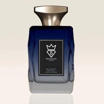 Bujairami New York Eau de Parfum — Blue gradient glass bottle with gold cap next to a navy blue box with gold lettering and