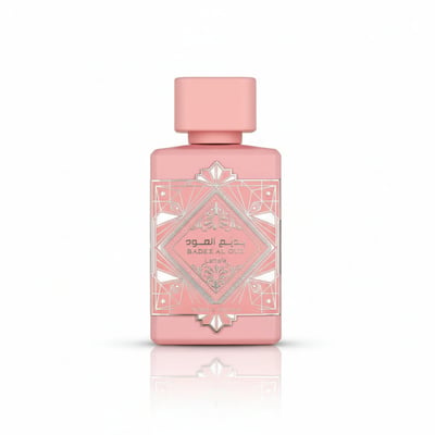 Pink perfume bottle with geometric design on a white background