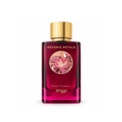 Zimaya Reverie Petals by Zimaya 100ml EDP Women — A woman's hand with dark red nails reaches for the gold cap of a deep red perfume bottle, next to its matching box, surrounded by dark red flowers and delicate white blossoms on a marble surface.