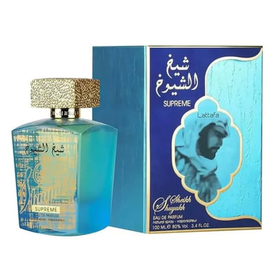 Lattafa Sheikh Al Shuyukh Supreme by Lattafa 100ml — A blue and green faceted glass perfume bottle with a gold textured cap sits next to its blue and light blue patterned box, which features an image of a man in traditional headwear. | Lattafa Sheikh Al Shuyukh Supreme by Lattafa 100ml — Botol kaca berfaset biru dan