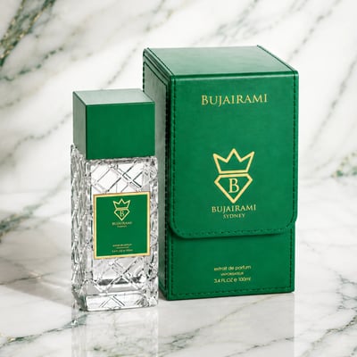 Bujairami Vibration by Bujairami 100ml Extrait de Parfum — Clear glass bottle with green cap and label next to a green
