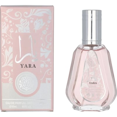 Ard Al Zaafaran Yara Eau De Parfum 50ml — Pink floral patterned box next to a faceted pale pink perfume bottle with a silver cap. | Ard Al Zaafaran Yara Eau De Parfum 50ml — Kotak bercorak bunga merah jambu di sebelah botol minyak wangi merah jambu pucat berfaset dengan penutup perak.