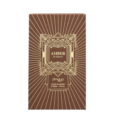 Zimaya Amber Is Great Eau De Parfum 100ml — A brown textured box with gold geometric art deco design stands next to a rectangular glass perfume bottle with a ribbed brown cap and gold geometric art deco design. The bottle contains amber-colored liquid. | Zimaya Amber Is Great Eau De Parfum 100ml — Kotak bertekstur