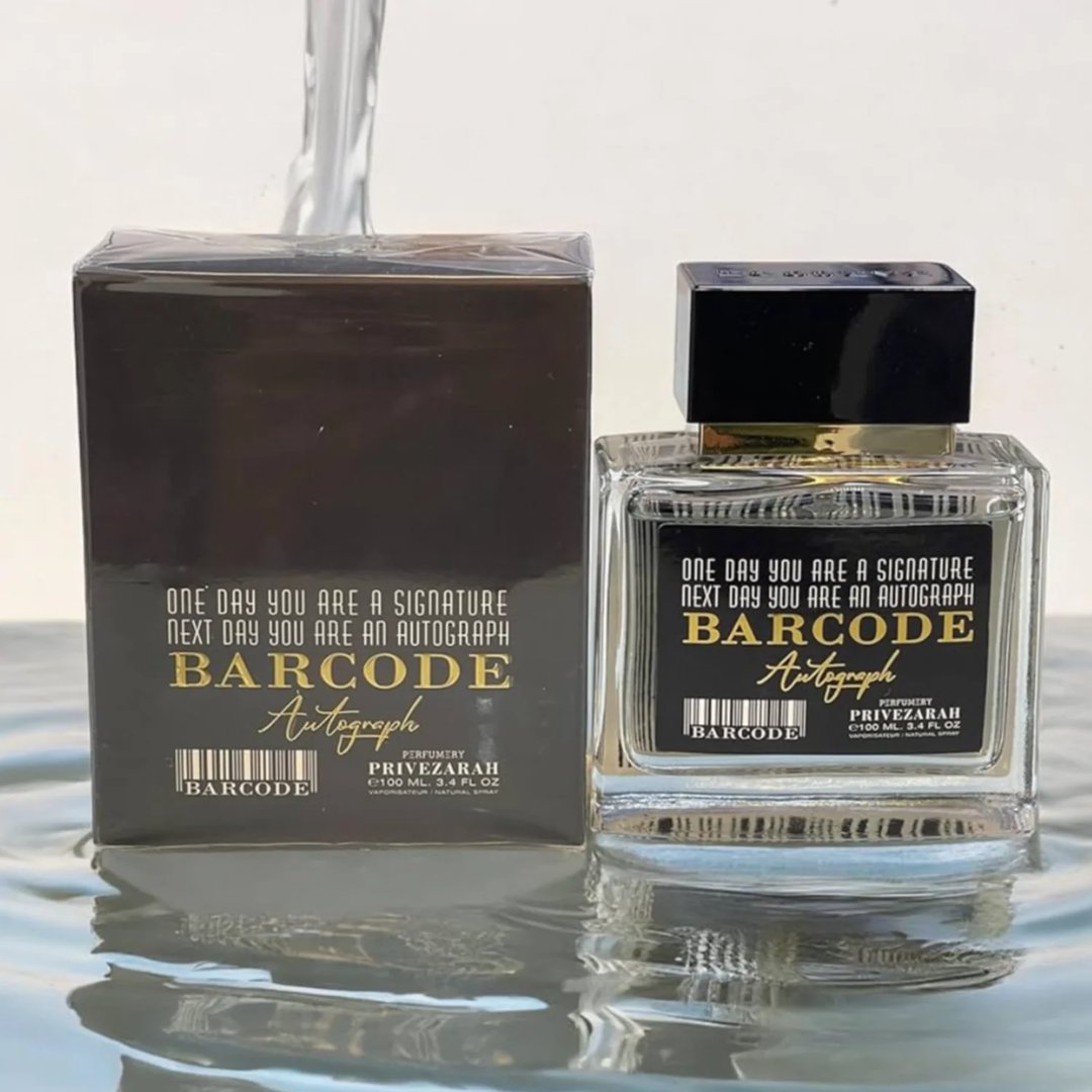 Paris Corner Autograph 100ml — A perfume bottle and its box are displayed side-by-side against a white background. Both feature a barcode design and the text "BARCODE Autograph" in gold lettering. | Paris Corner Autograph 100ml — Sebotol minyak wangi dan kotaknya dipamerkan bersebelahan di atas latar belakang putih.