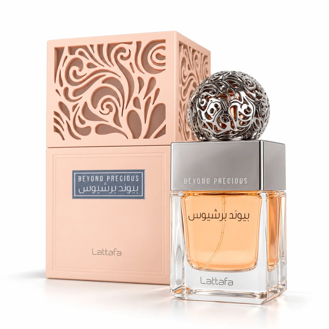 Lattafa Beyond Precious by Lattafa 100ml EDP Women — Clear glass perfume bottle with orange liquid, silver ornate sphere cap, and a peach decorative box with intricate cutouts.