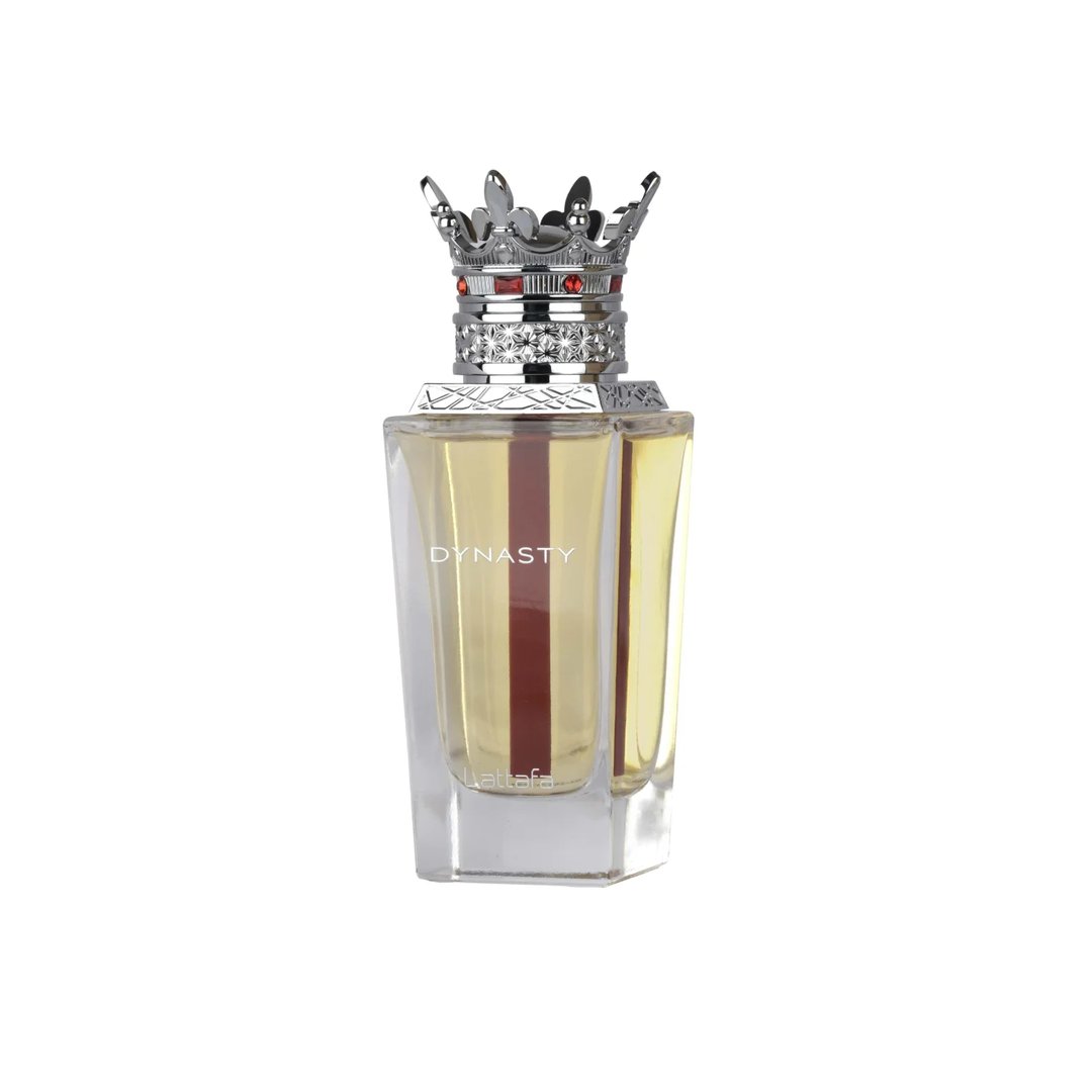 Lattafa Dynasty Lattafa 100ml EDP Unisex — A maroon textured box with a white ornate crest sits next to a clear glass perfume bottle topped with a silver crown-shaped cap with red accents.
