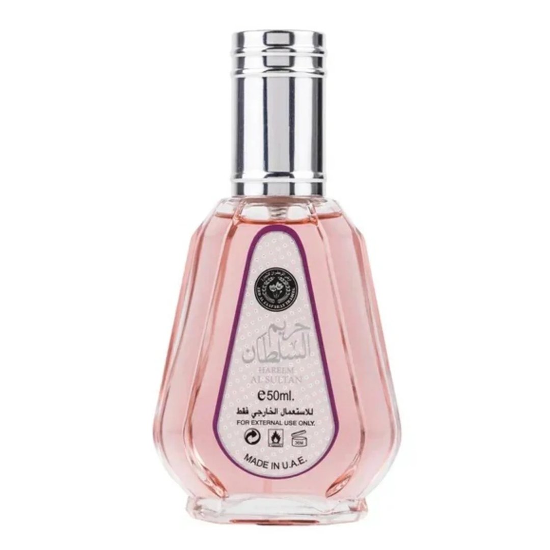Ard Al Zaafaran Hareem Al Sultan EDP 50ml — A pink perfume bottle with a silver cap and a patterned label sits next to its matching pink and gold patterned box with a circular purple design. | Ard Al Zaafaran Hareem Al Sultan EDP 50ml — Sebotol minyak wangi merah jambu dengan penutup perak dan label bercorak terletak