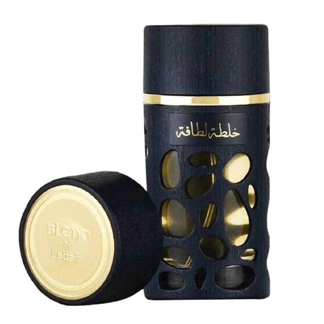 Lattafa Khalta Blend Of Lattafa Eau De Parfum 100ml — A dark blue perfume bottle with gold accents and a cutout design, next to its matching dark box and cap, all on a white reflective surface. | Lattafa Khalta Blend Of Lattafa Eau De Parfum 100ml — Botol minyak wangi biru gelap dengan aksen emas dan rekaan potongan