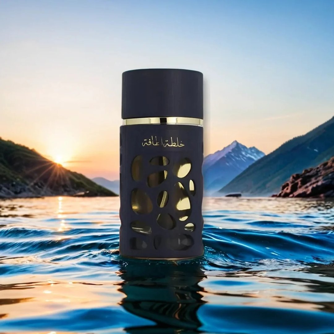 Lattafa Khalta Blend Of Lattafa Eau De Parfum 100ml — A dark blue perfume bottle with gold accents and a cutout design, next to its matching dark box and cap, all on a white reflective surface. | Lattafa Khalta Blend Of Lattafa Eau De Parfum 100ml — Botol minyak wangi biru gelap dengan aksen emas dan rekaan potongan