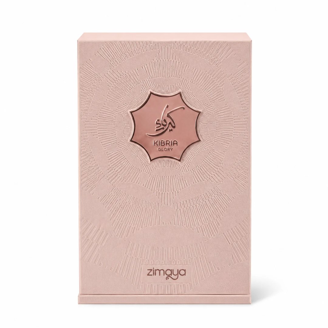 Zimaya Kibria Glory — Rose gold perfume bottle with crown cap and matching textured box, both featuring embossed Arabic script and 'KIBRIA GLORY' text.