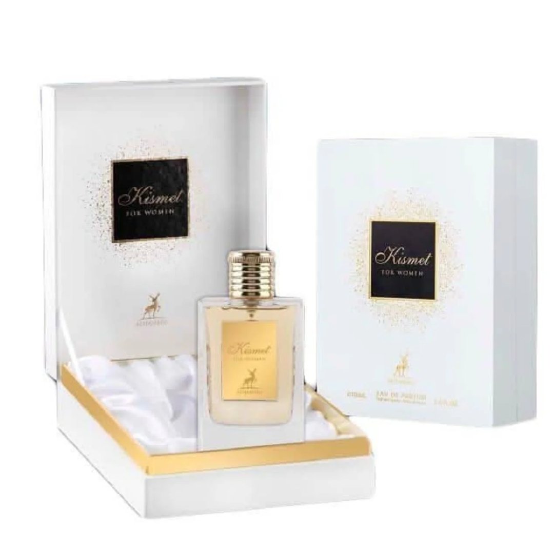 Maison Alhambra Kismet for Women 100ml by Maison Alhambra — A white box and a clear glass perfume bottle with gold accents and a deer emblem, displayed against a white background. | Maison Alhambra Kismet for Women 100ml by Maison Alhambra — Peti putih dan botol minyak wangi kaca jernih dengan perincian emas dan