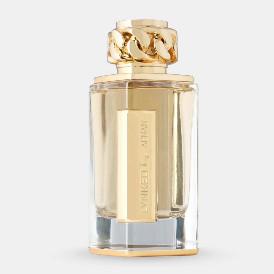 Afnan Lynked Forever by Afnan 100ml Eau De Parfum — A gold-capped perfume bottle stands next to its rose gold box with