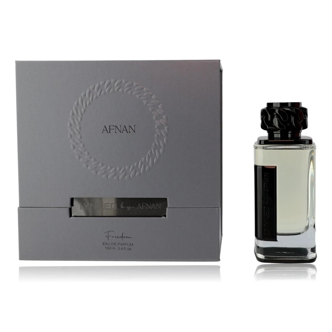 Afnan Lynked Freedom by Afnan — Gray gift box with embossed circle and text, next to a clear glass perfume bottle with black