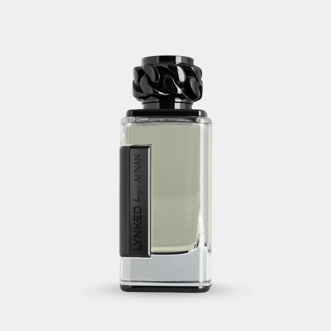 Afnan Lynked Freedom by Afnan — Gray gift box with embossed circle and text, next to a clear glass perfume bottle with black