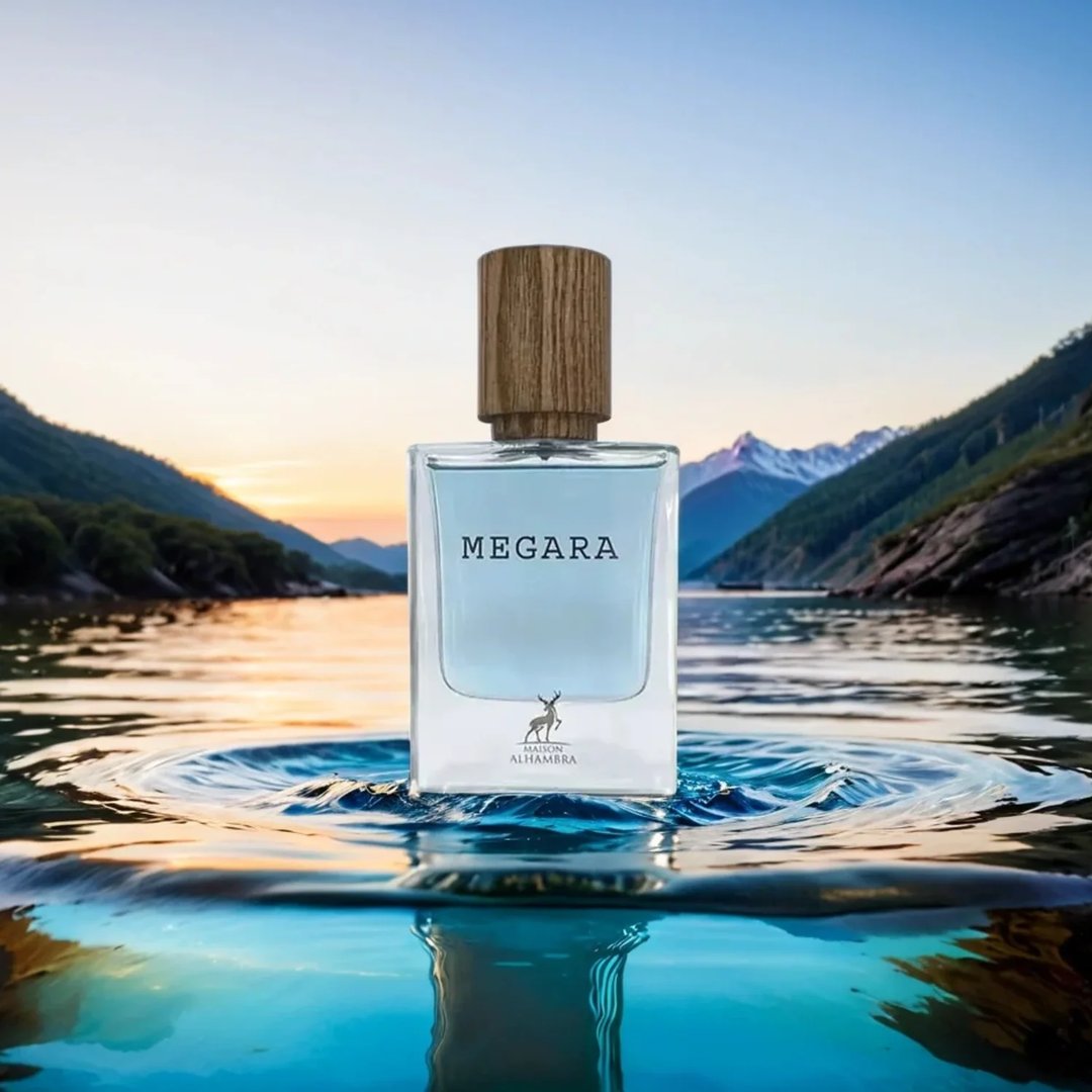 Maison Alhambra Megara 50ml Maison Alhambra — Brown cardboard box with red tree root design and text "MEGARA" next to a clear glass perfume bottle with blue liquid and a wooden cap, featuring the "Maison Alhambra" logo on both. | Maison Alhambra Megara 50ml Maison Alhambra — Kotak kadbod perang dengan reka bentuk akar