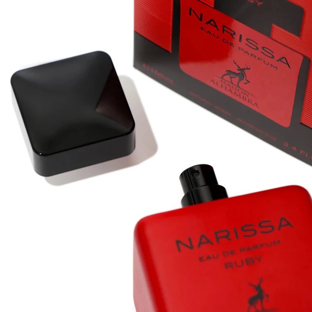 Maison Alhambra Narissa Ruby Rouge Maison Alhambra 100ml — A red perfume bottle and its matching red box are displayed against a white background. | Maison Alhambra Narissa Ruby Rouge Maison Alhambra 100ml — Sebotol minyak wangi merah dan kotak merah yang sepadan dipaparkan berlatarkan putih.