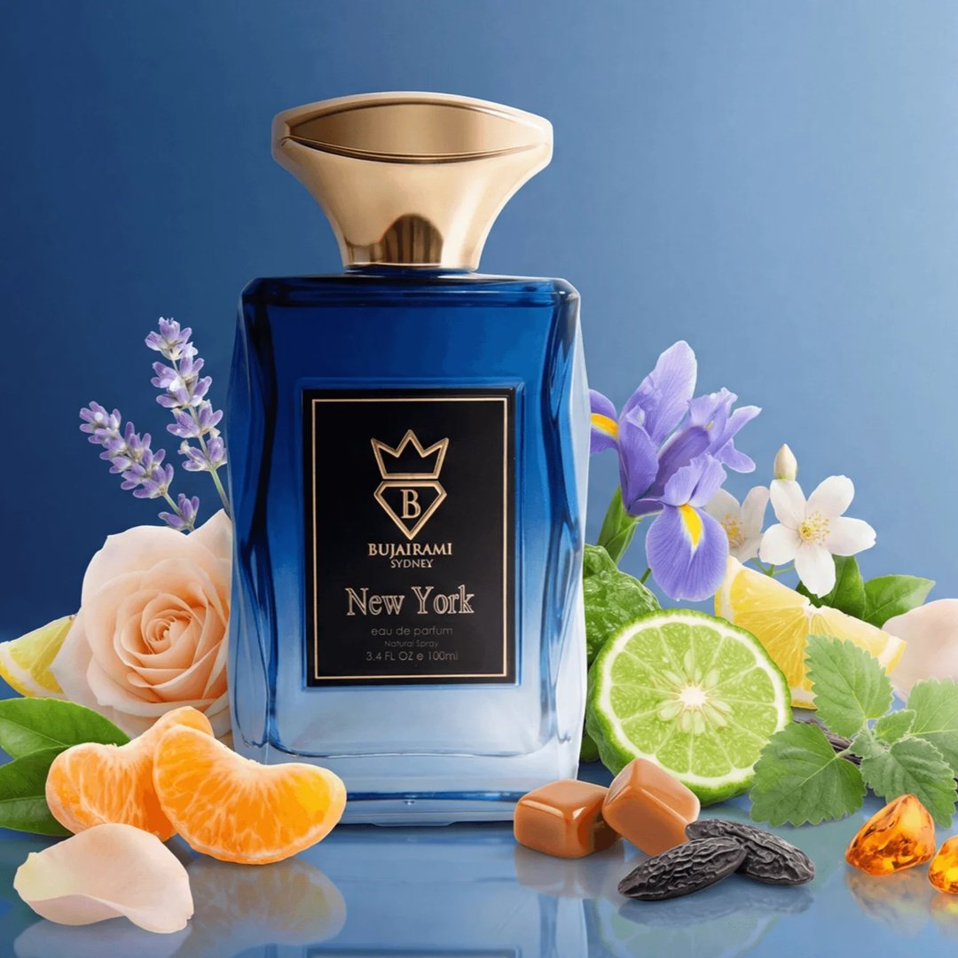 Bujairami New York Eau de Parfum — Blue gradient glass bottle with gold cap next to a navy blue box with gold lettering and