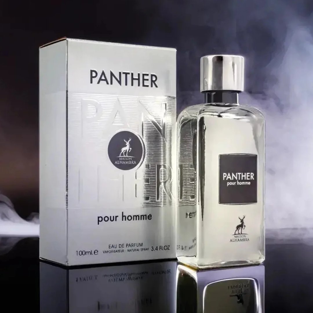 Maison Alhambra Panther Pour Homme — White glass perfume bottle with a dark label and a white box with embossed text and a deer logo. | Botol minyak wangi kaca putih Maison Alhambra Panther Pour Homme dengan label gelap dan kotak putih bertekstur timbul serta logo rusa.