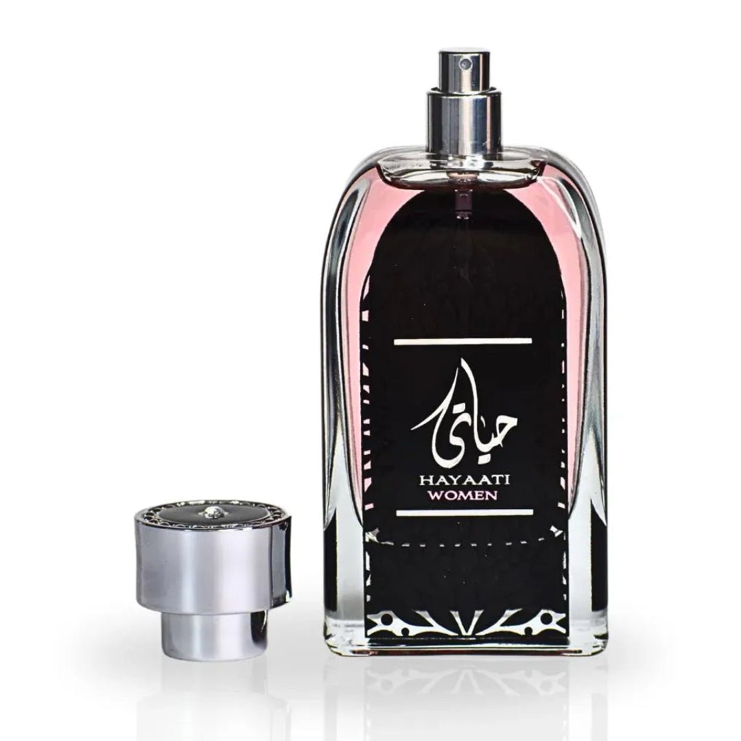 Perfume bottle with black label and silver cap on a white background