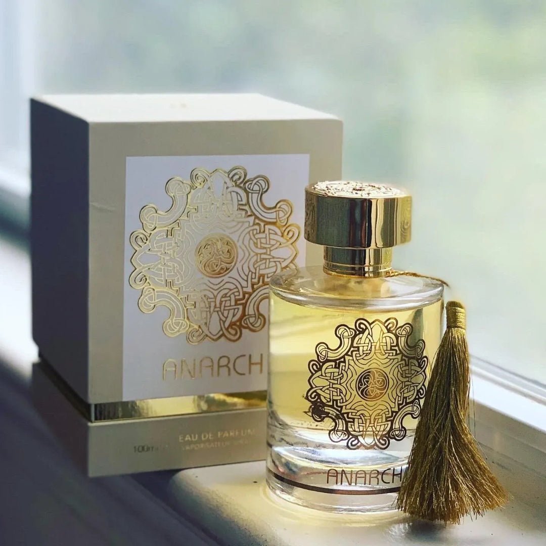 Anarch Alhambra women with decorative label and tassel next to its packaging on a reflective surface.