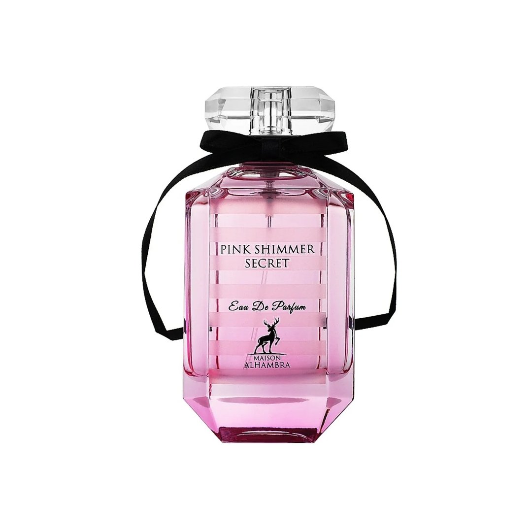 Maison Alhambra Pink Shimmer Secret 100ml — Pink perfume bottle with a black ribbon bow, next to its matching pink striped box, on a white background. | Maison Alhambra Pink Shimmer Secret 100ml — Botol minyak wangi merah jambu dengan reben hitam, bersebelahan kotak berjalur merah jambu yang sepadan, di atas latar