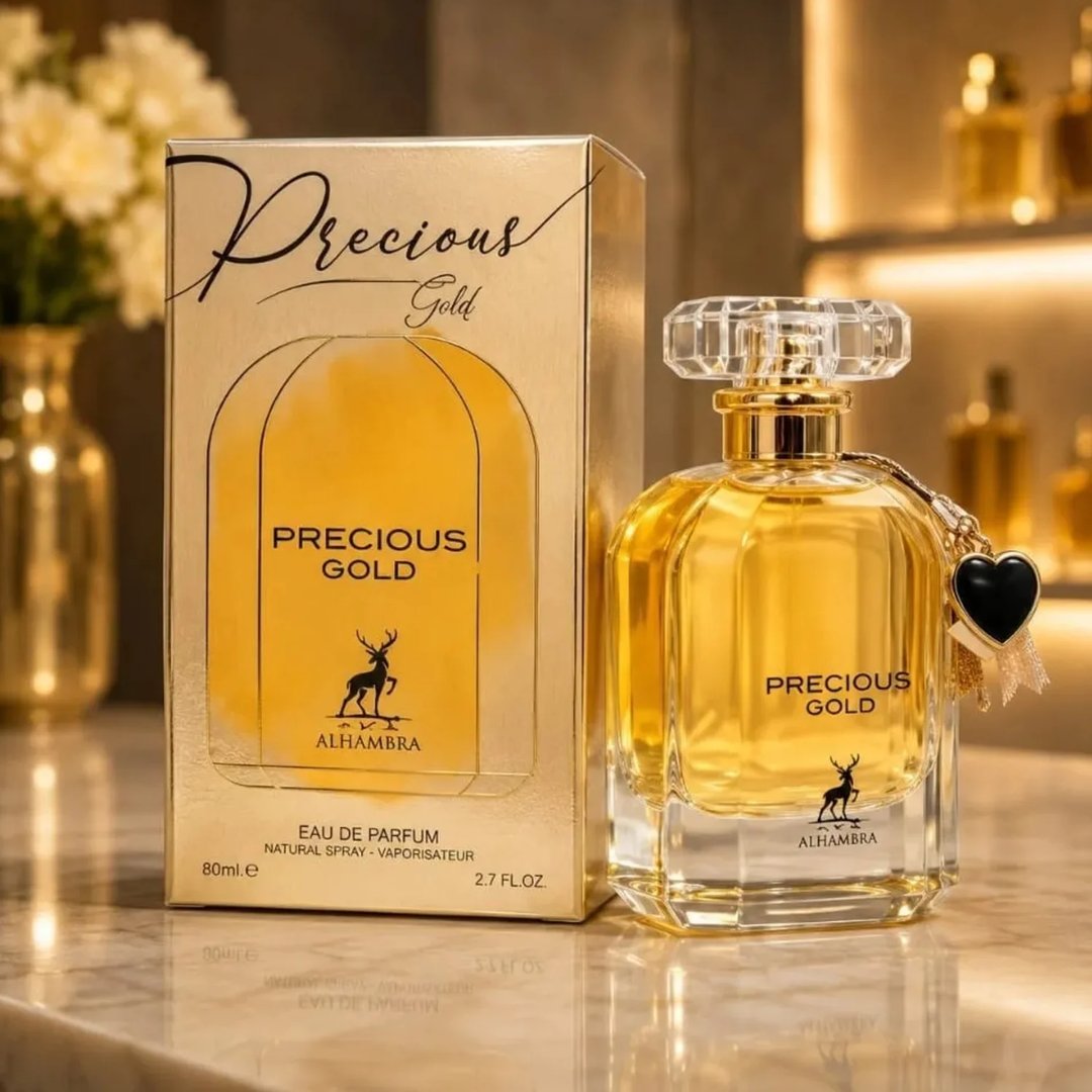 Maison Alhambra Precious Gold 80ml by Maison Alhambra — A gold-themed perfume box and bottle are displayed side-by-side against a white background. The box features abstract gold brushstrokes and a deer silhouette, while the bottle contains golden liquid and has a heart-shaped charm. | Maison Alhambra Precious Gold
