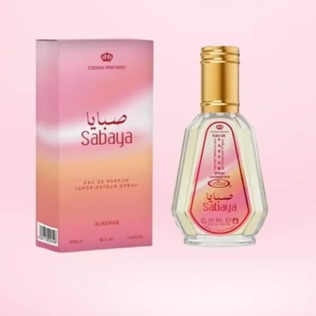 Al Rehab Sabaya 50ml EDP — A clear glass perfume bottle with a peach-colored cap sits next to its pink and yellow gradient box, both featuring the Sabaya branding. | Al Rehab Sabaya 50ml EDP — Botol minyak wangi kaca jernih dengan penutup berwarna pic duduk di sebelah kotak gradien merah jambu dan kuningnya