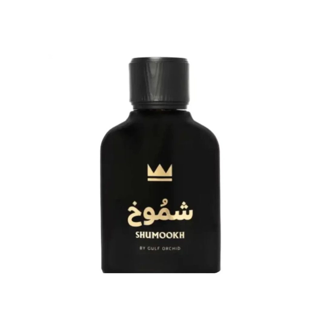 Gulf Orchid Shumookh Parfum 100ml Gulf Orchid — Black perfume bottle and its black and white patterned box with gold crown and Arabic text | Gulf Orchid Shumookh Parfum 100ml Gulf Orchid — Botol minyak wangi hitam dan kotaknya yang bercorak hitam putih dengan mahkota emas dan teks Arab