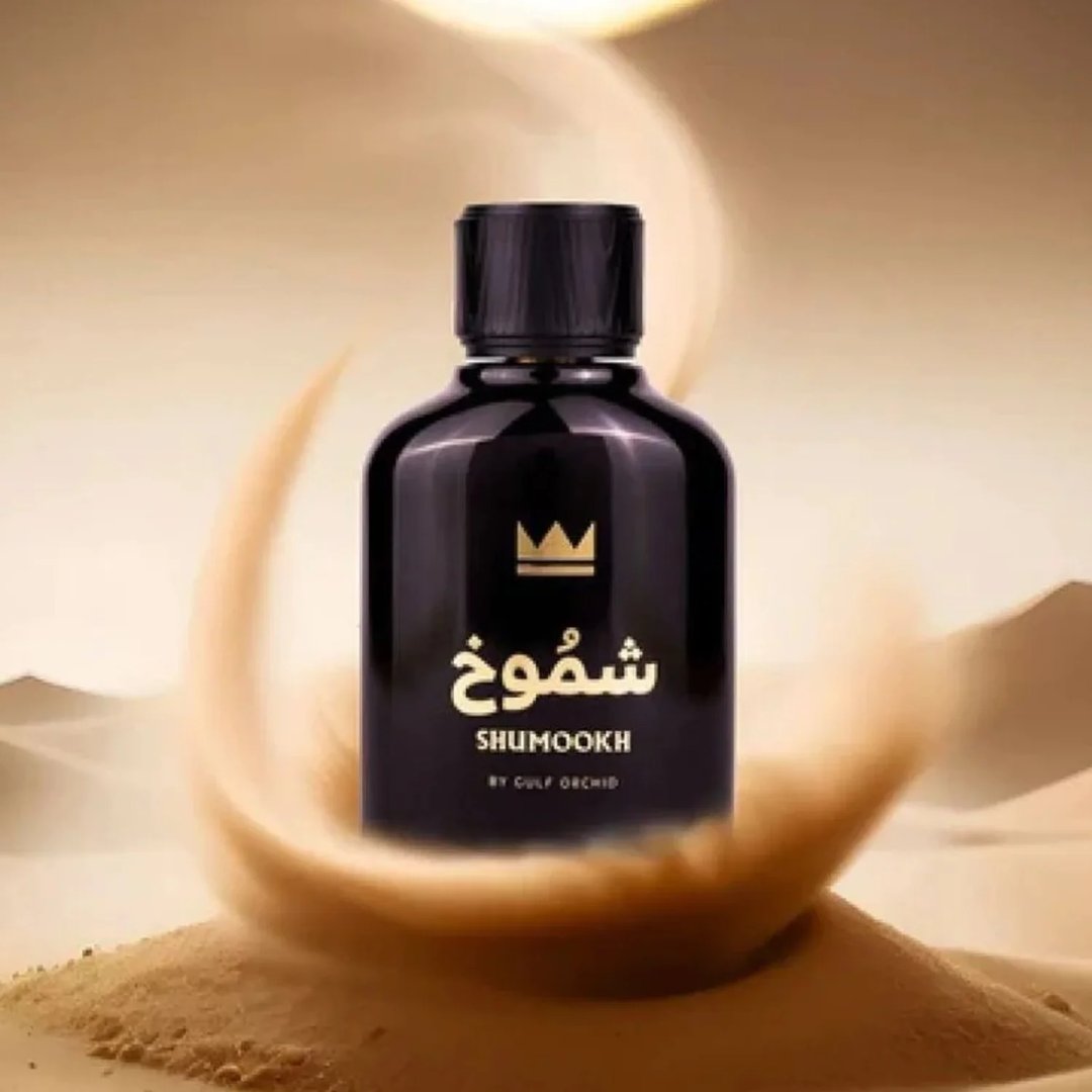 Gulf Orchid Shumookh Parfum 100ml Gulf Orchid — Black perfume bottle and its black and white patterned box with gold crown and Arabic text | Gulf Orchid Shumookh Parfum 100ml Gulf Orchid — Botol minyak wangi hitam dan kotaknya yang bercorak hitam putih dengan mahkota emas dan teks Arab