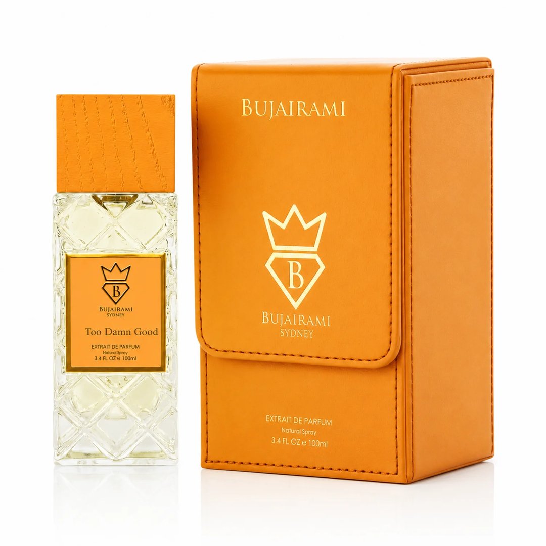 Bujairami Too Damn Good — Clear faceted glass perfume bottle with wooden cap next to orange leather box with gold logo