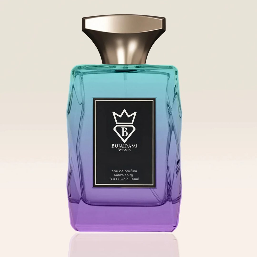 Bujairami Unforgettable Eau de Parfum — A faceted glass perfume bottle with a gold cap sits next to its gradient purple and