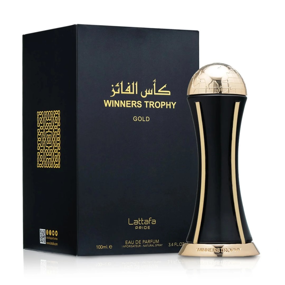 Lattafa Pride Al Khas Winners Trophy Gold 100ml — A black perfume box with gold Arabic and English text, and a gold-capped black perfume bottle shaped like an hourglass, displayed on a white background. | Lattafa Pride Al Khas Winners Trophy Gold 100ml — Kotak minyak wangi hitam dengan teks Arab dan Inggeris emas, dan