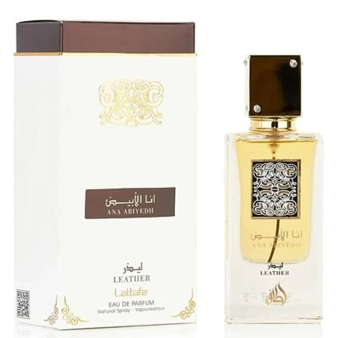 Lattafa Ana Abiyedh Leather 60ml by Lattafa Perfumes — A white perfume box with gold Arabic calligraphy and a clear glass bottle with gold accents and a dark brown cap, displayed side-by-side. | Lattafa Ana Abiyedh Leather 60ml by Lattafa Perfumes — Kotak minyak wangi putih dengan kaligrafi Arab emas dan botol kaca