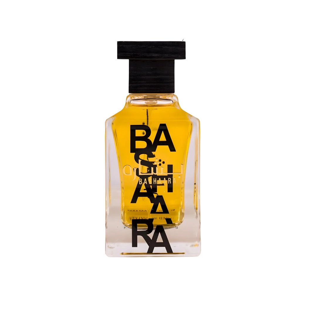 Ard Al Zaafaran Bashaara Eau De Parfum 100ml — Clear glass bottle with yellow liquid and black text "BA SHAARA" repeated vertically, black wooden cap | Ard Al Zaafaran Bashaara Eau De Parfum 100ml — Botol kaca jernih dengan cecair kuning dan teks hitam "BA SHAARA" berulang secara menegak, penutup kayu hitam